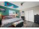 Cozy bedroom with a large bed, grey laminate flooring, and a ceiling fan at 24 Sapphire Way, Ocala, FL 34472