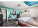 Bright bedroom featuring a ceiling fan, grey laminate flooring, a guitar, and a large dresser at 24 Sapphire Way, Ocala, FL 34472