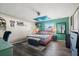 Cozy bedroom with a ceiling fan, colorful accent wall, and ample natural light at 24 Sapphire Way, Ocala, FL 34472