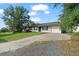 Traditional one-story home featuring a driveway, well-maintained lawn, and a two-car garage at 24 Sapphire Way, Ocala, FL 34472