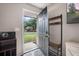 Welcoming foyer with coat rack, offering a glimpse of the beautifully landscaped front yard at 24 Sapphire Way, Ocala, FL 34472