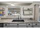Close-up of a kitchen featuring granite countertops, a black sink, and open shelving at 24 Sapphire Way, Ocala, FL 34472