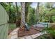 Backyard with stone path, tub shower, and mature landscaping at 5881 Avenue H, Mc Intosh, FL 32664