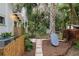 Backyard featuring a stone walkway, outdoor shower, and lush, mature landscaping at 5881 Avenue H, Mc Intosh, FL 32664