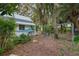 Backyard with mature landscaping featuring an outdoor shower at 5881 Avenue H, Mc Intosh, FL 32664