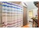 Bathroom featuring a striped shower curtain and wooden cabinets at 5881 Avenue H, Mc Intosh, FL 32664