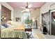 Relaxing bedroom with a ceiling fan, light walls, and a decorative barn door leading to an ensuite at 5881 Avenue H, Mc Intosh, FL 32664
