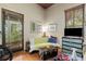 Sitting area includes wood floors, vintage trunk and bright light from the large windows at 5881 Avenue H, Mc Intosh, FL 32664