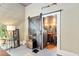 Stylish bedroom with a sliding barn door entrance to the ensuite bathroom with natural light at 5881 Avenue H, Mc Intosh, FL 32664
