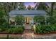 Charming home featuring mature landscaping, brick path, and a welcoming front porch at 5881 Avenue H, Mc Intosh, FL 32664
