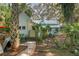 Exterior view of home featuring cottage charm and delightful landscaping at 5881 Avenue H, Mc Intosh, FL 32664