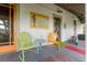Comfortable front porch featuring vintage-style chairs and a charming aesthetic at 5881 Avenue H, Mc Intosh, FL 32664