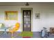 Welcoming front porch view with seating and decorative elements at 5881 Avenue H, Mc Intosh, FL 32664
