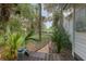Charming front yard with lush palm trees, garden and a partial view of the home at 5881 Avenue H, Mc Intosh, FL 32664