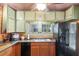 Kitchen featuring granite counters, wood cabinets, tile backsplash, and stainless appliances at 5881 Avenue H, Mc Intosh, FL 32664
