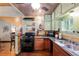 Kitchen featuring gas range, wood cabinets, hardwood floors, and stainless sink at 5881 Avenue H, Mc Intosh, FL 32664