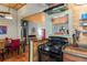 Charming kitchen featuring a black gas range, granite counters, and an open layout to the dining area at 5881 Avenue H, Mc Intosh, FL 32664