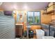 Convenient laundry room equipped with modern washer and dryer, ample shelving and vibrant wall color at 5881 Avenue H, Mc Intosh, FL 32664