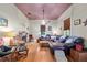 Cozy living room featuring a fireplace, wood floors, and natural light at 5881 Avenue H, Mc Intosh, FL 32664