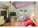 Living room with hardwood floors, tv and access to outside deck at 5881 Avenue H, Mc Intosh, FL 32664