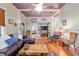 Open-concept living room with hardwood floors and charming decor throughout at 5881 Avenue H, Mc Intosh, FL 32664