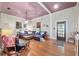 Spacious living room with wood floors, vintage furnishings, and natural light at 5881 Avenue H, Mc Intosh, FL 32664