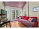 Cozy living room with hardwood floors, bright window, and access to the outside at 5881 Avenue H, Mc Intosh, FL 32664
