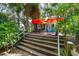 Elevated wooden deck and stairs leading to a private backyard oasis at 5881 Avenue H, Mc Intosh, FL 32664
