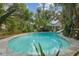 An inviting in-ground pool with mature trees and lush landscaping at 5881 Avenue H, Mc Intosh, FL 32664