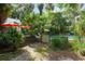 Backyard with steps down to a private in-ground pool surrounded by trees at 5881 Avenue H, Mc Intosh, FL 32664