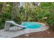 Backyard in-ground pool with a white slide and a flagstone pool deck at 5881 Avenue H, Mc Intosh, FL 32664