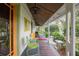 Spacious porch area with vintage furniture, ideal for outdoor relaxation at 5881 Avenue H, Mc Intosh, FL 32664