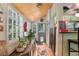 Bright sunroom boasts large windows, wood floors, and a cozy atmosphere with plants and stylish decor at 5881 Avenue H, Mc Intosh, FL 32664