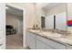 A bright bathroom features a double sink with granite countertops and white cabinets, offering practical elegance at 8123 Sw 57Th Ct, Ocala, FL 34476