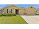 Inviting single-Gathering home with a well-manicured lawn and a two-car garage, showcasing charming exterior details at 8123 Sw 57Th Ct, Ocala, FL 34476