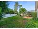 Large backyard with green grass, a white fence, patio and mature landscaping at 916 Ashmeade Ct, Port Orange, FL 32127
