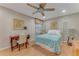 Cozy bedroom with a ceiling fan, a writing desk, soft decor and ample natural light at 916 Ashmeade Ct, Port Orange, FL 32127