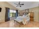 Cozy bedroom with natural light, vaulted ceiling, wood-look flooring, and bench seating at 916 Ashmeade Ct, Port Orange, FL 32127