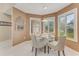 Bright breakfast nook featuring a glass table, upholstered chairs, plantation shutters, and modern lighting at 916 Ashmeade Ct, Port Orange, FL 32127