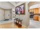 Inviting foyer showcases hardwood floors, decorative artwork, and a glimpse into the modern kitchen at 916 Ashmeade Ct, Port Orange, FL 32127