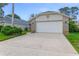 A two-car garage with a wide driveway and well-maintained landscaping at 916 Ashmeade Ct, Port Orange, FL 32127