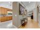 Spacious hallway featuring wood flooring, a glass table, and views of kitchen and living areas at 916 Ashmeade Ct, Port Orange, FL 32127