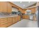 A kitchen with wood cabinets, stainless steel appliances, and tiled backsplash, with a window view to the outside at 916 Ashmeade Ct, Port Orange, FL 32127