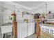 Practical laundry room equipped with a washer, dryer, sink, and ample shelving for storage and laundry organization at 916 Ashmeade Ct, Port Orange, FL 32127