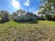 View of the rear of the home with an expansive backyard and mature trees at 11027 Sw 75Th Ave, Ocala, FL 34476