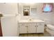 Bathroom featuring a white vanity with a large mirror, and toilet and shower at 11027 Sw 75Th Ave, Ocala, FL 34476