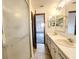 Bathroom with double sinks, shower, and view into the bedroom at 11027 Sw 75Th Ave, Ocala, FL 34476
