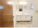 Bright bathroom with white vanity with new mirror and fixtures at 11027 Sw 75Th Ave, Ocala, FL 34476
