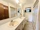 Bathroom featuring a double sink vanity, walk-in shower, and tile floor at 11027 Sw 75Th Ave, Ocala, FL 34476