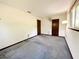Bedroom with gray carpet, 2 dark doors, fan and simple lamp at 11027 Sw 75Th Ave, Ocala, FL 34476